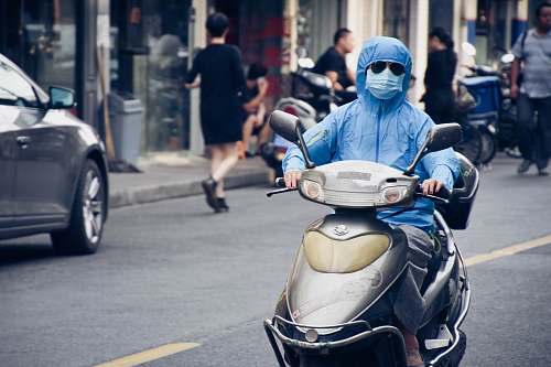 person person driving motor scooter automobile