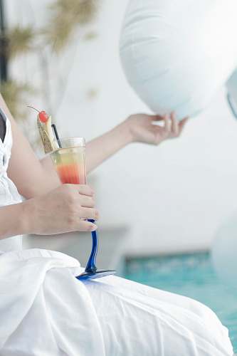person person holding glass of juice and white balloon clinic