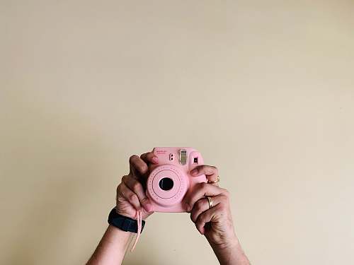 person person holding pin camera electronics