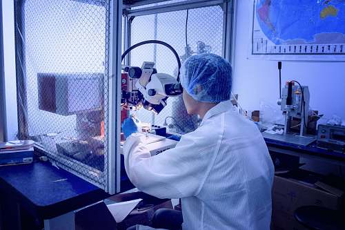 person person in front of white microscope clinic