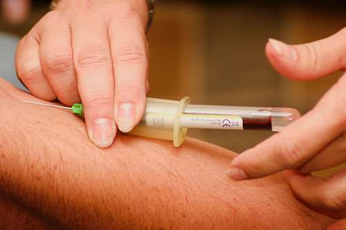 medical person injecting syringe injection