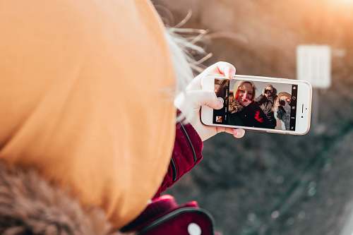 person person taking selfie on her gold iPhone 6 face
