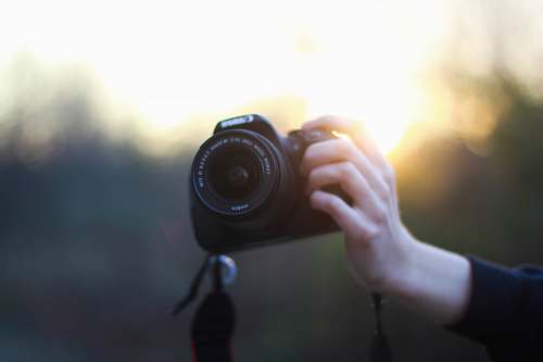 person person using Canon DSLR camera camera