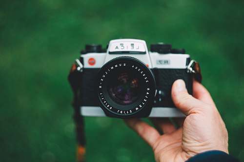 person selective focus photography of camera electronics