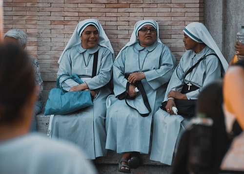 person three nuns sitting apparel