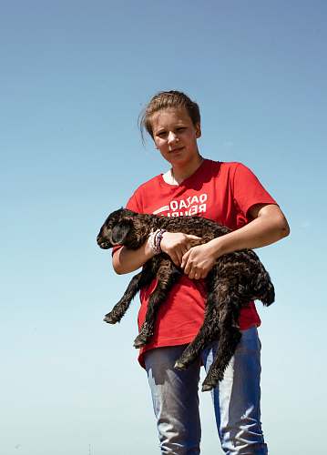 person woman carrying goat kid apparel