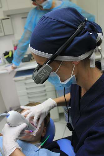 person woman holding white medical tool clinic