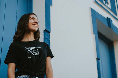 people woman standing near white and blue building person