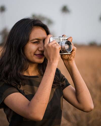 person woman taking photo camera