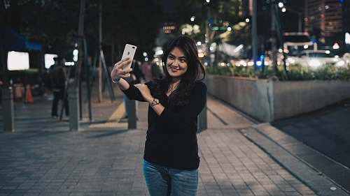 person woman taking selfie near outdoor during nighttime face