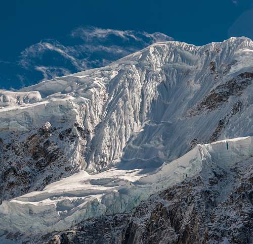 mountain brown stone mountain covered by snow glacier