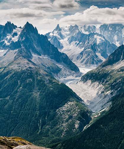 nature aerial view photography of mountains under cloudy sky glacier