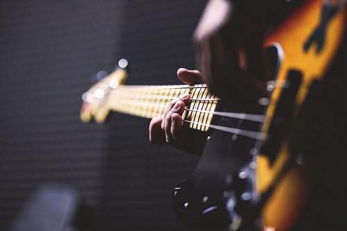 guitar closeup photo of person playing guitar electric guitar