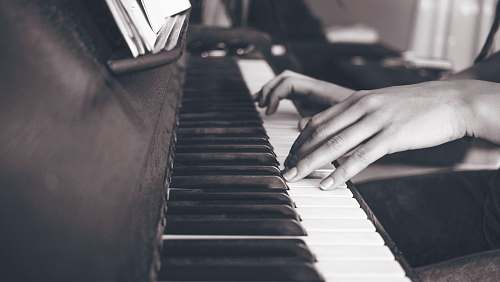 piano person playing upright piano in sephia photography hands