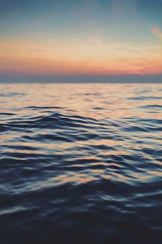 ocean calm body of water at golden hour water