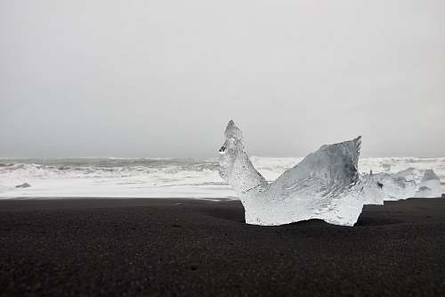outdoors ice on black beach sand ice