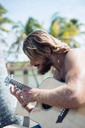 person man holding acoustic guitar human