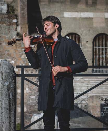 human man playing violin at daytime violin