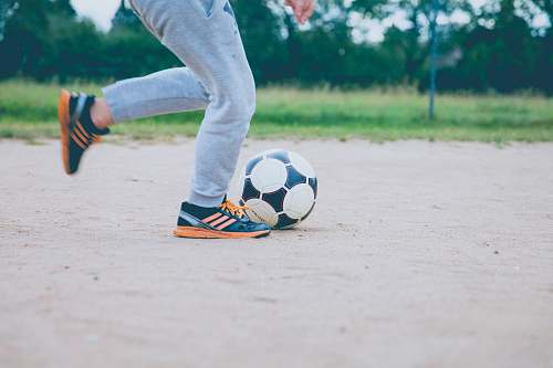 person person plays soccer ball on white sands sport
