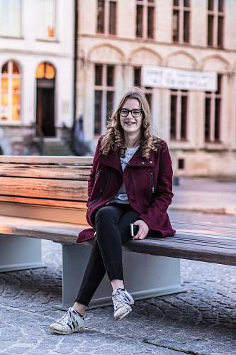 human smiling woman sitting on bench person