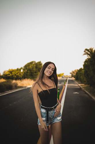 human smiling woman standing under gray sky person
