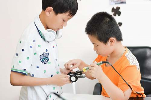 human boy soldering car toy white sitting on chair people
