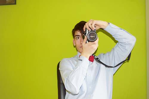 human man holding DSLR camera people