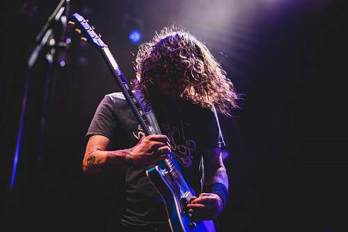 music man playing electric guitar performer