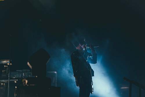 music person holding microphone smoke