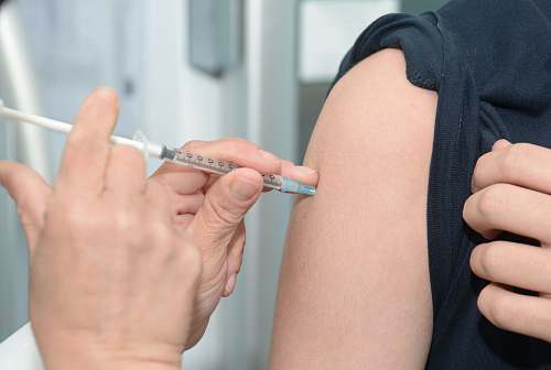human person injecting someone on his arm people