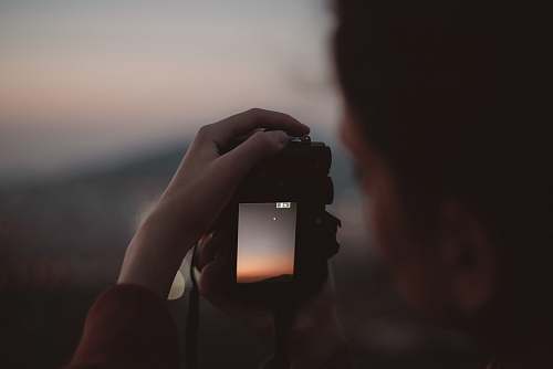 human person taking photo of the stars photo