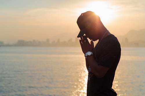 human silhouette photo of man in black crew-neck shirt during golden hour photo