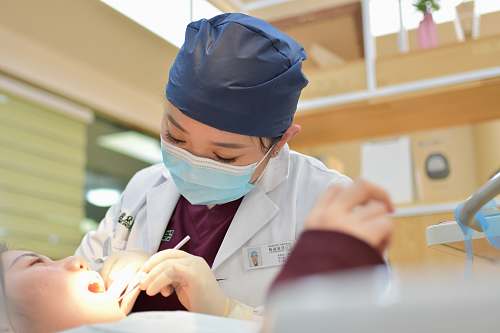 human woman doing dental on girl lying on bed dentist