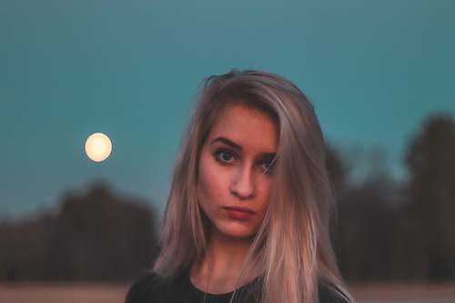 human woman standing near tree during nighttime face
