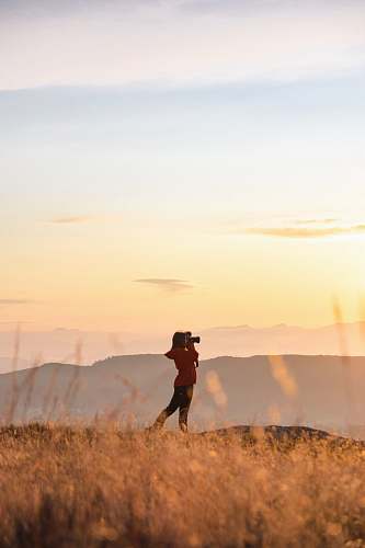 human woman standing on brown field photo