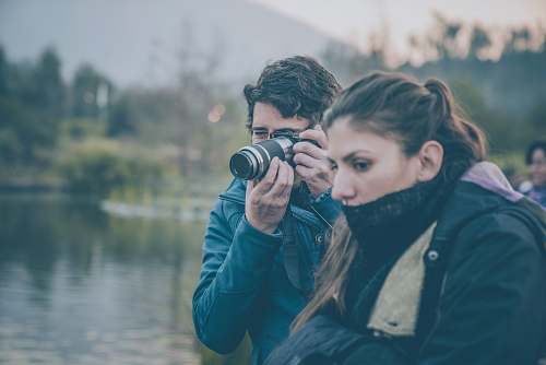 human man and woman beside body of water person