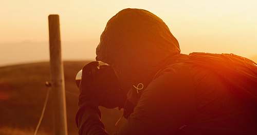 human man taking shots during golden hour person
