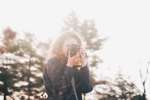 human woman using DSLR camera person