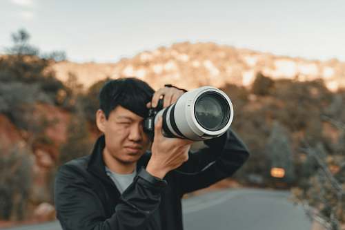 human white and black DSLR camera person