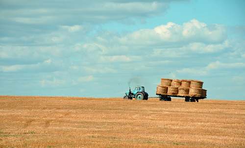 blue brown hay on tractor under white and blue sky during daytime hay