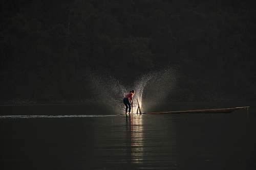 vietnam person standing on boat playing water fishing