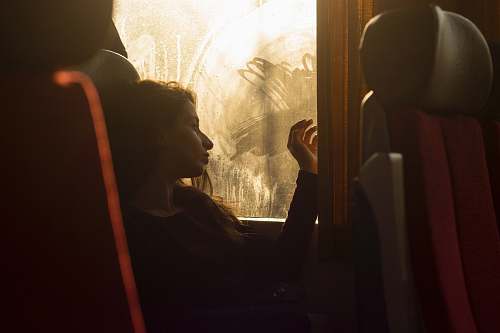 train woman sitting on chair near window female