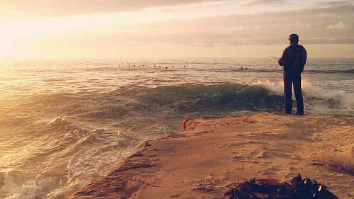 person man standing on seashore people
