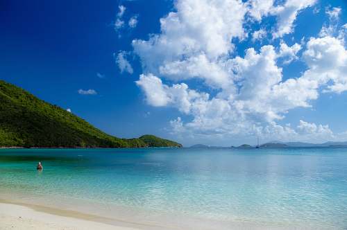 ocean person swimming on beach during daytime outdoors