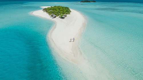maldives two person walking on islet during daytime alifu alifu atoll