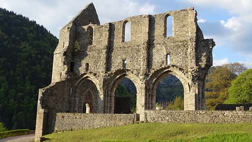 ruins gray concrete wall at daytime 961 route de l'abbaye