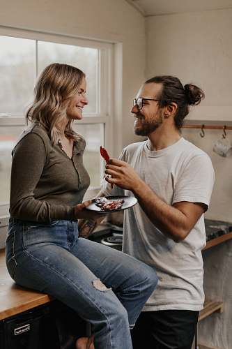 person woman in gray crew neck t-shirt and blue denim jeans sitting on black chair apparel