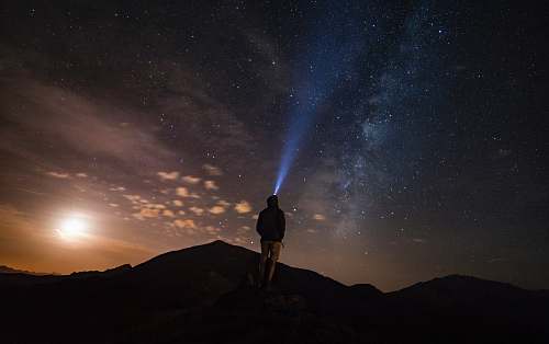 outdoors man standing at mountain peak under starry night sky human