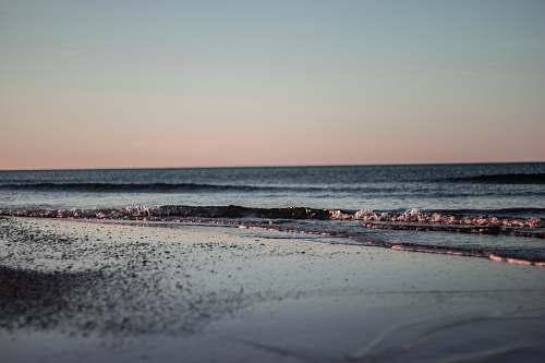 beach waves crashing on shore during daytime sea