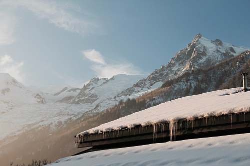 nature snow-covered roof and mountain under blue sky mountain